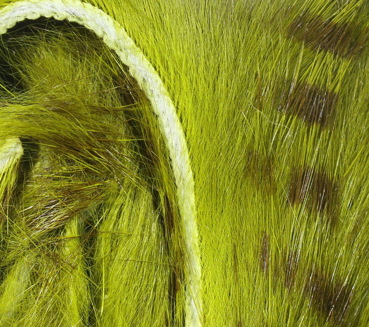 Chartreuse-dyed brown-barred rabbit fur strips for fly tying, dense soft fur with brown bars and stitched backing