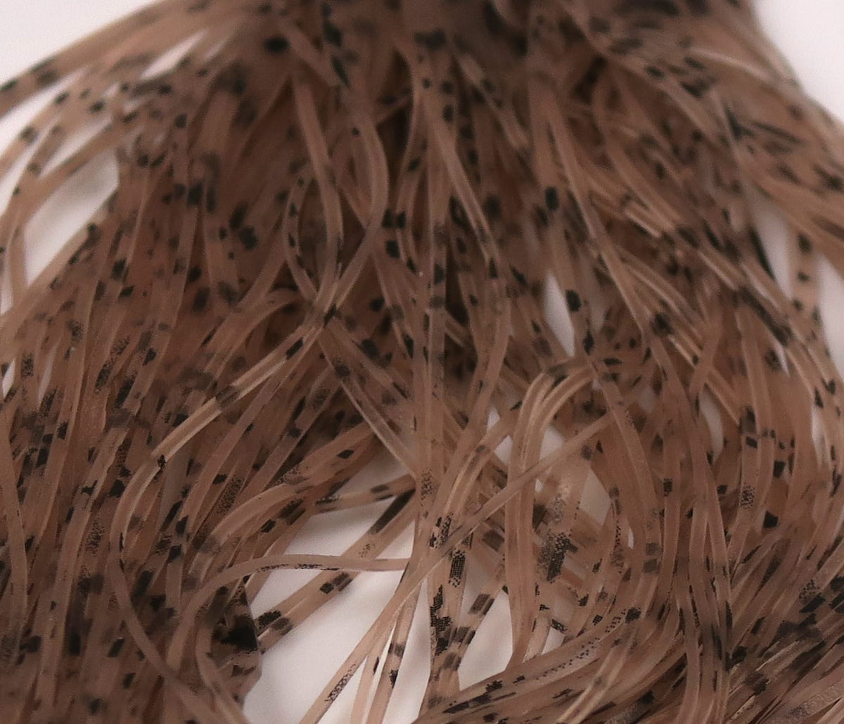 Hareline Buggy Nymph Legs brown-tan synthetic strands with black speckles for fly tying, thin flexible nymph legs