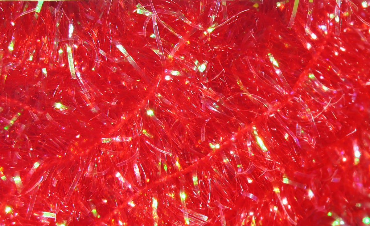 Bright red Hareline Cactus Chenille with iridescent tinsel strands, fluffy synthetic fly tying material