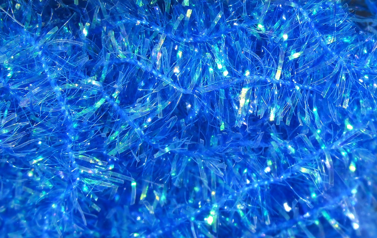 Bright electric blue Hareline cactus chenille with iridescent, spiky synthetic fibers for fly tying
