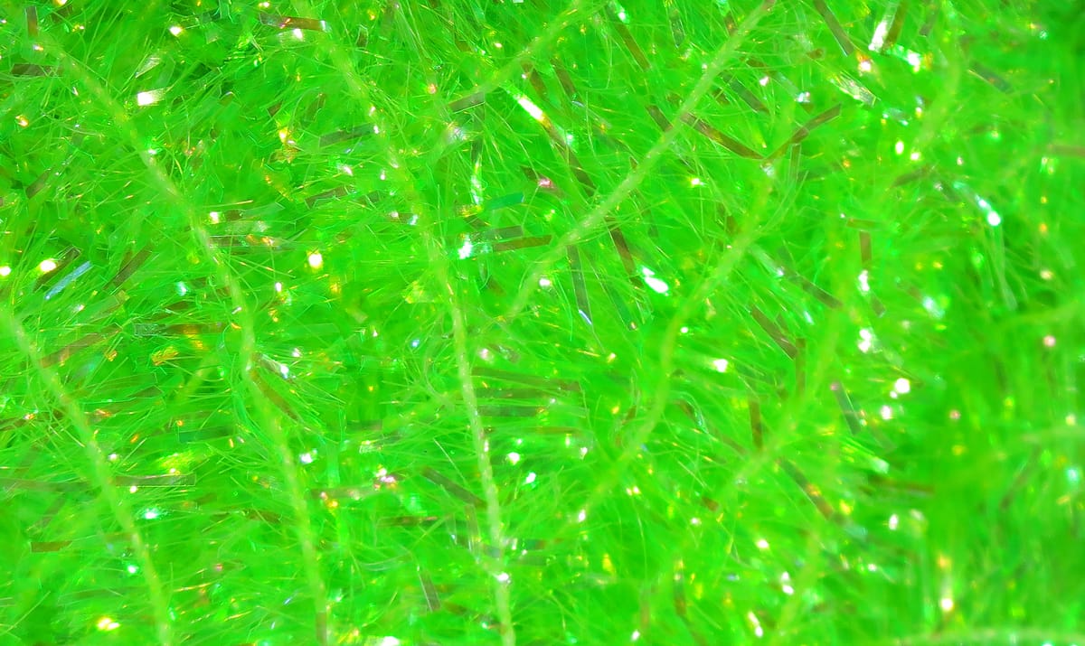 Chartreuse cactus chenille with fuzzy synthetic fibers and iridescent tinsel strands for fly tying