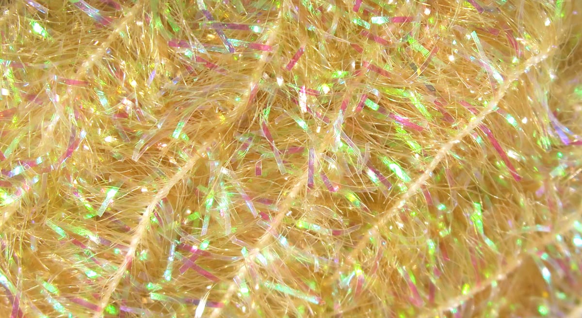 Hareline cactus chenille in pale gold with iridescent tinsel flash, fuzzy synthetic fly tying material
