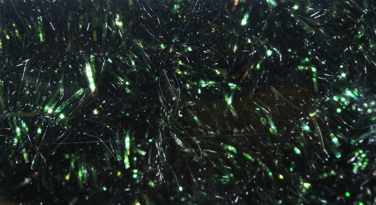 Dark emerald Hareline cactus chenille with iridescent green metallic fibers and fluffy tinsel texture for fly tying