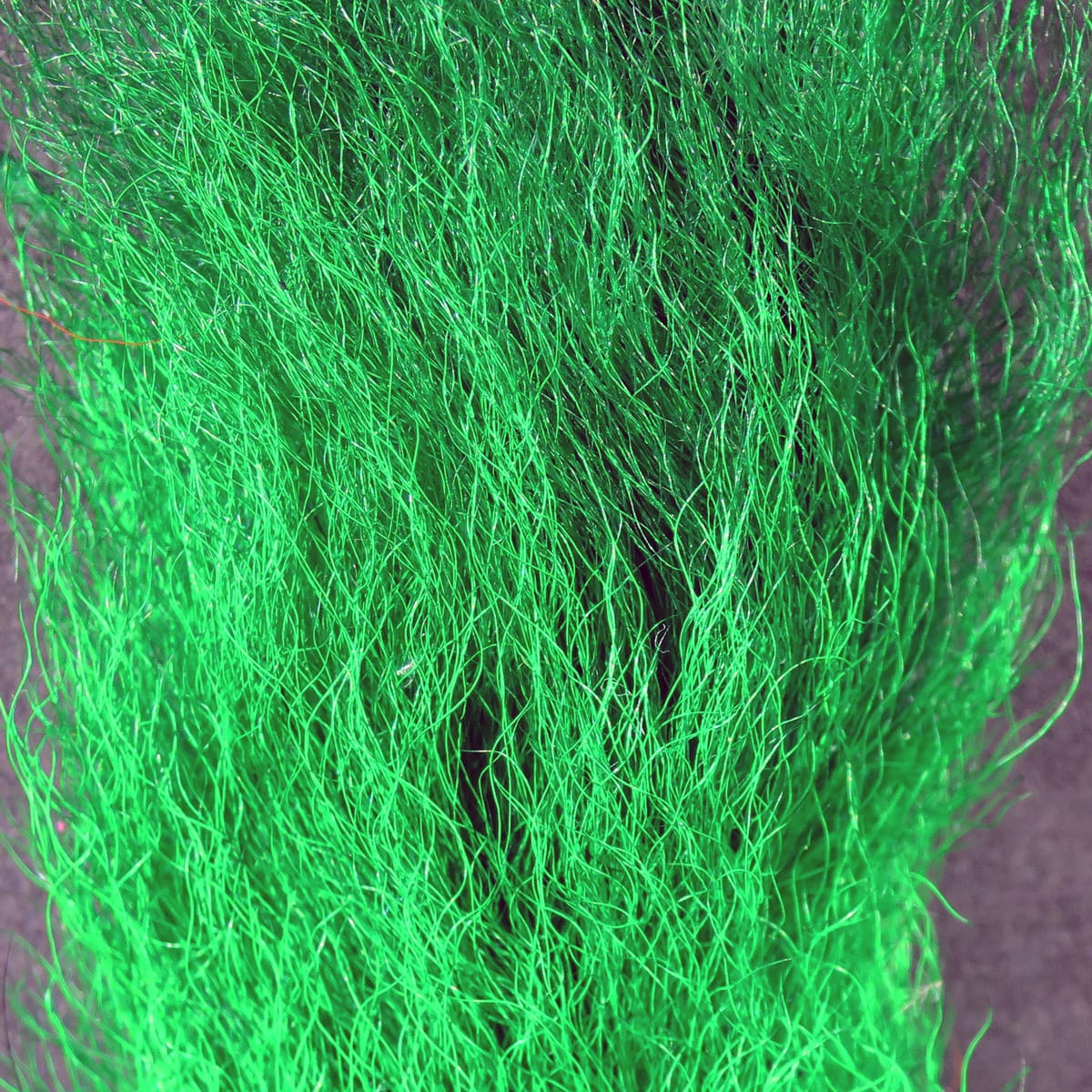 Neon green dyed calf tails, long wispy hair fibers with glossy sheen for fly tying
