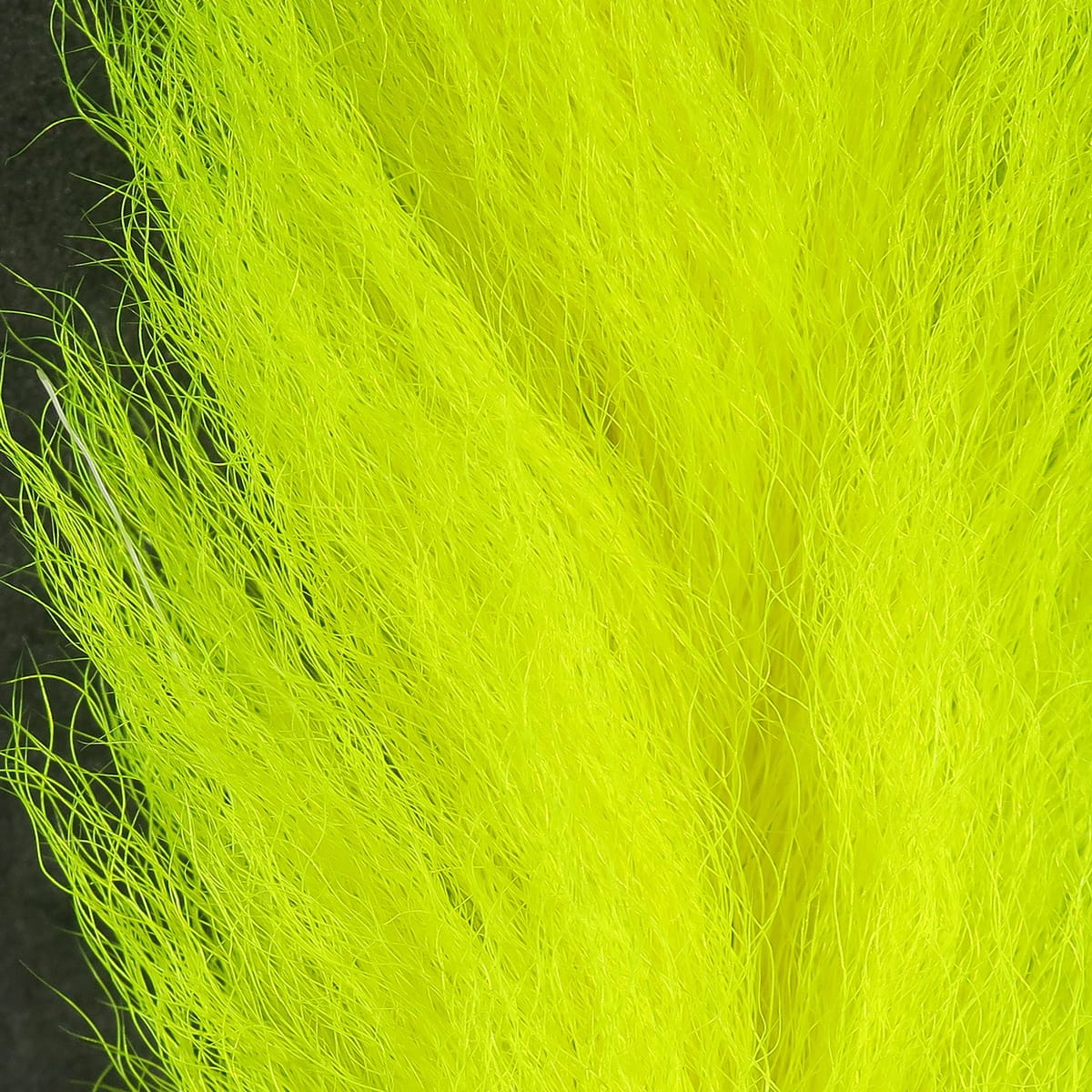 Hareline Calf Tails fly tying material in fluorescent chartreuse, long wispy calf hair fibers for streamers and tails