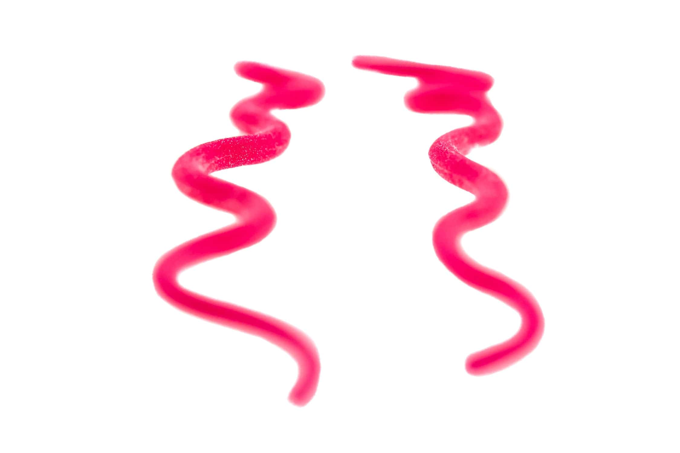 Two fluorescent pink foam curly Squirmito strands with soft, spiral worm-like texture for fly tying