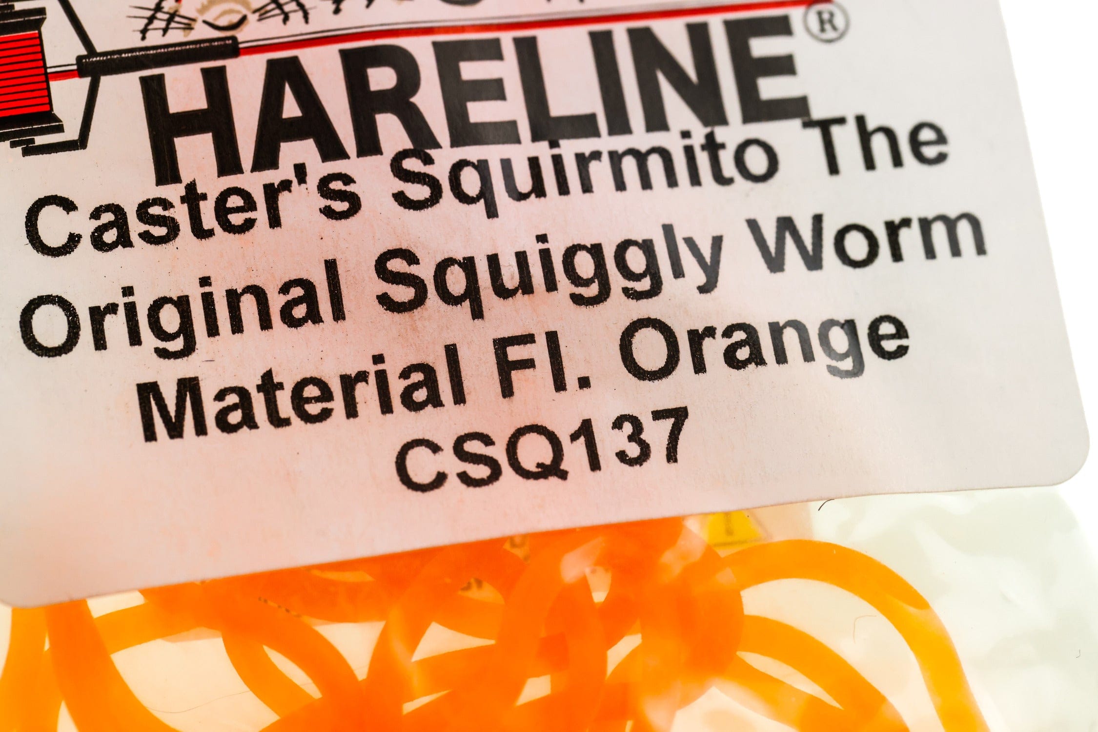 Bright fluorescent orange rubber squiggly worm material labeled Hareline Caster's Squirmito for fly tying