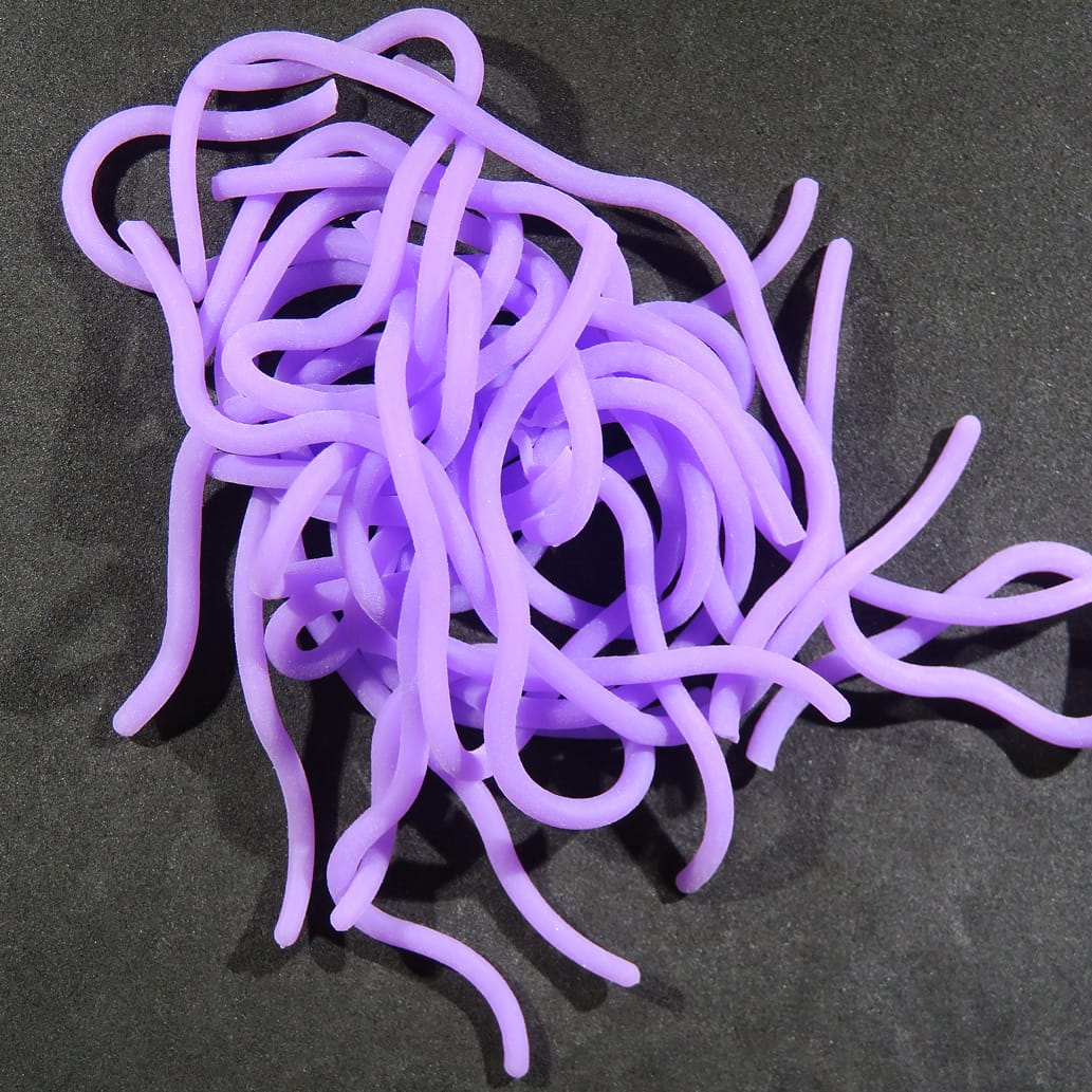 Bright purple silicone squirmy worm strands for fly tying, soft tubular lure material