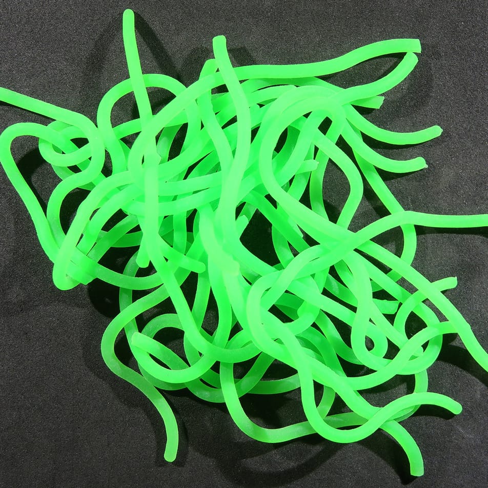 Neon chartreuse rubber Squirmito strands, soft tubular squirmy bait for fly tying, tangled on black background