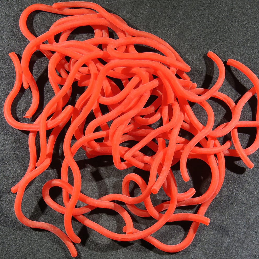 Bright orange soft rubber Squirmito strands resembling bloodworms, flexible rubber worms for fly tying lures