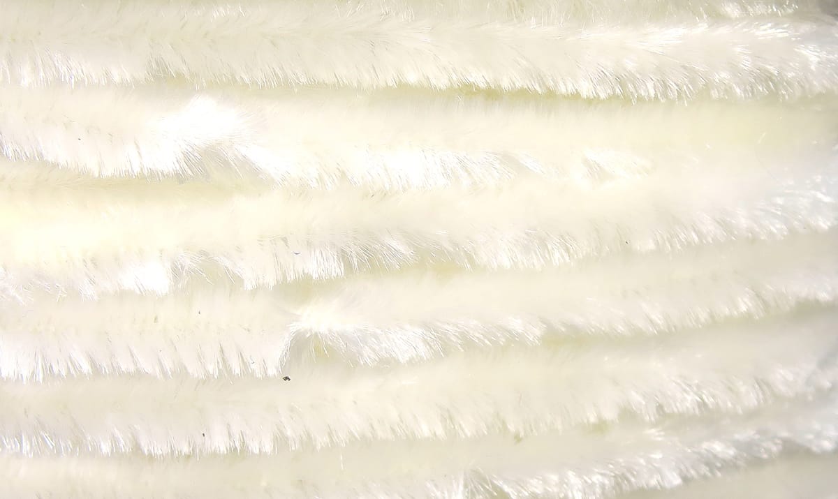 White Hareline chenille plush synthetic fibers with subtle sheen for fly tying