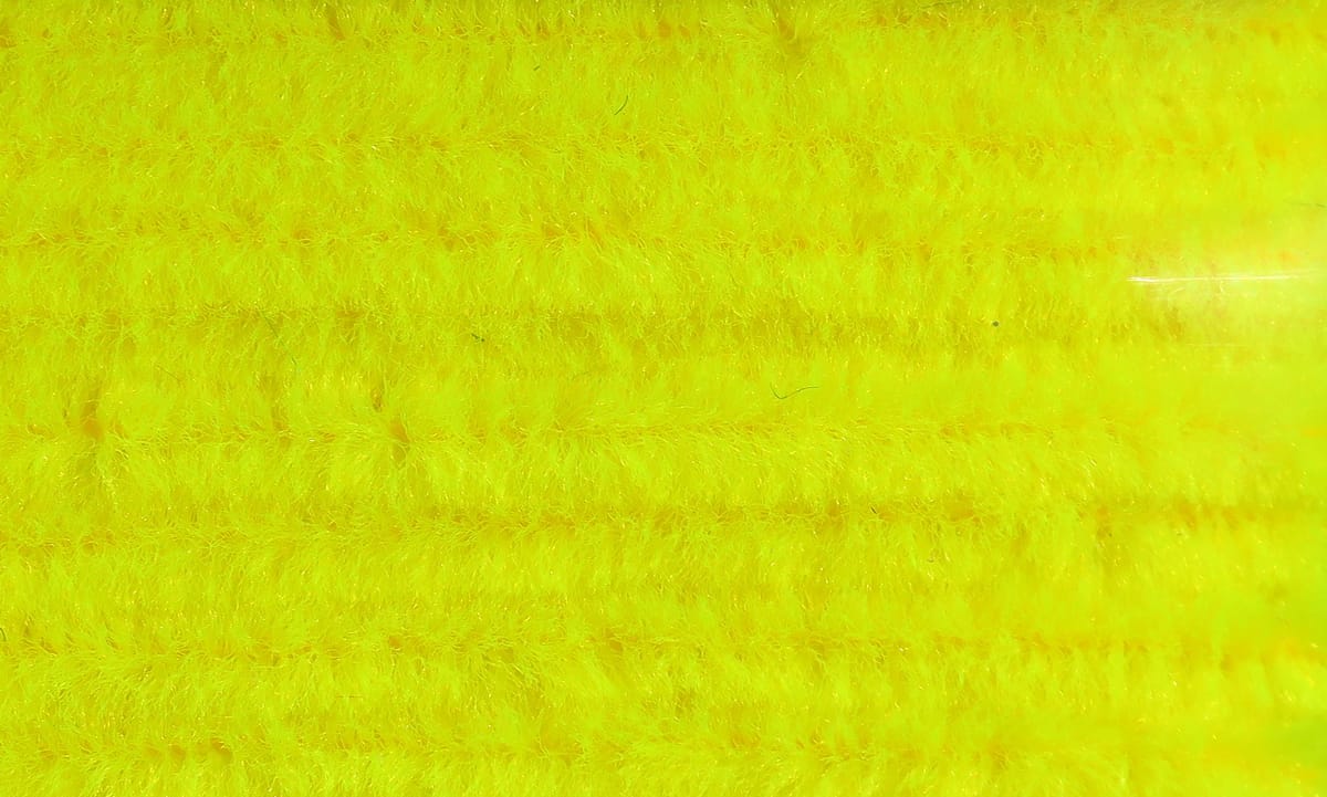Bright chartreuse yellow Hareline chenille yarn with dense fuzzy fibers, sparkly iridescent strands for fly tying