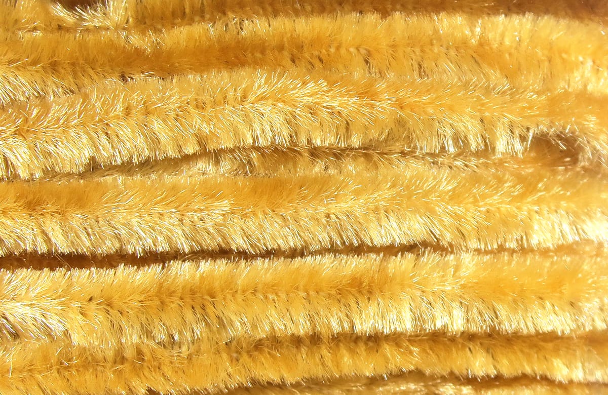 Golden yellow Hareline chenille stems with sparkly synthetic fuzzy fibers, plush fly tying material