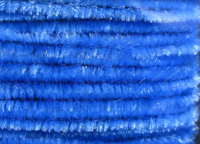 Bright blue Hareline chenille with fuzzy sparkly fibers, close-up fly tying material showing dense plush texture