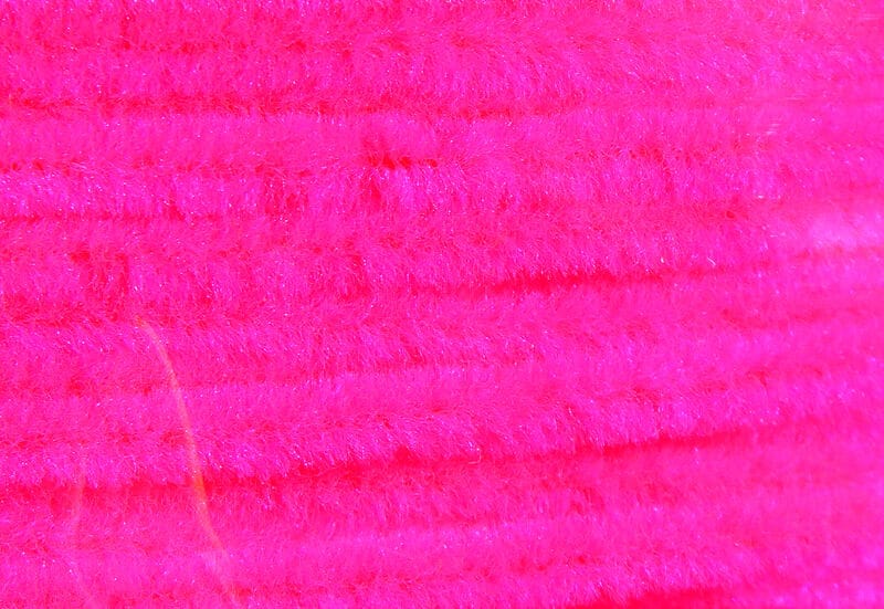 Hareline chenille in neon pink, fuzzy synthetic fibers with ribbed pipe-cleaner texture for fly tying