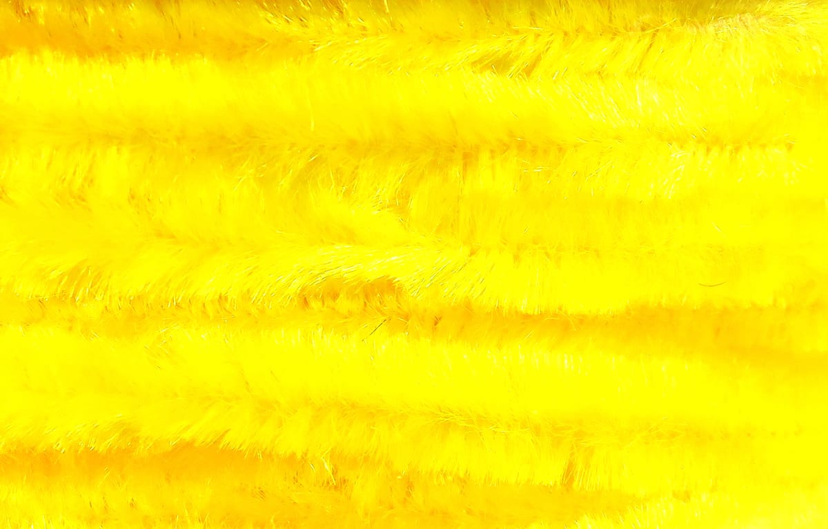 Bright yellow Hareline chenille strands, plush fuzzy synthetic fibers for fly tying with shimmery texture
