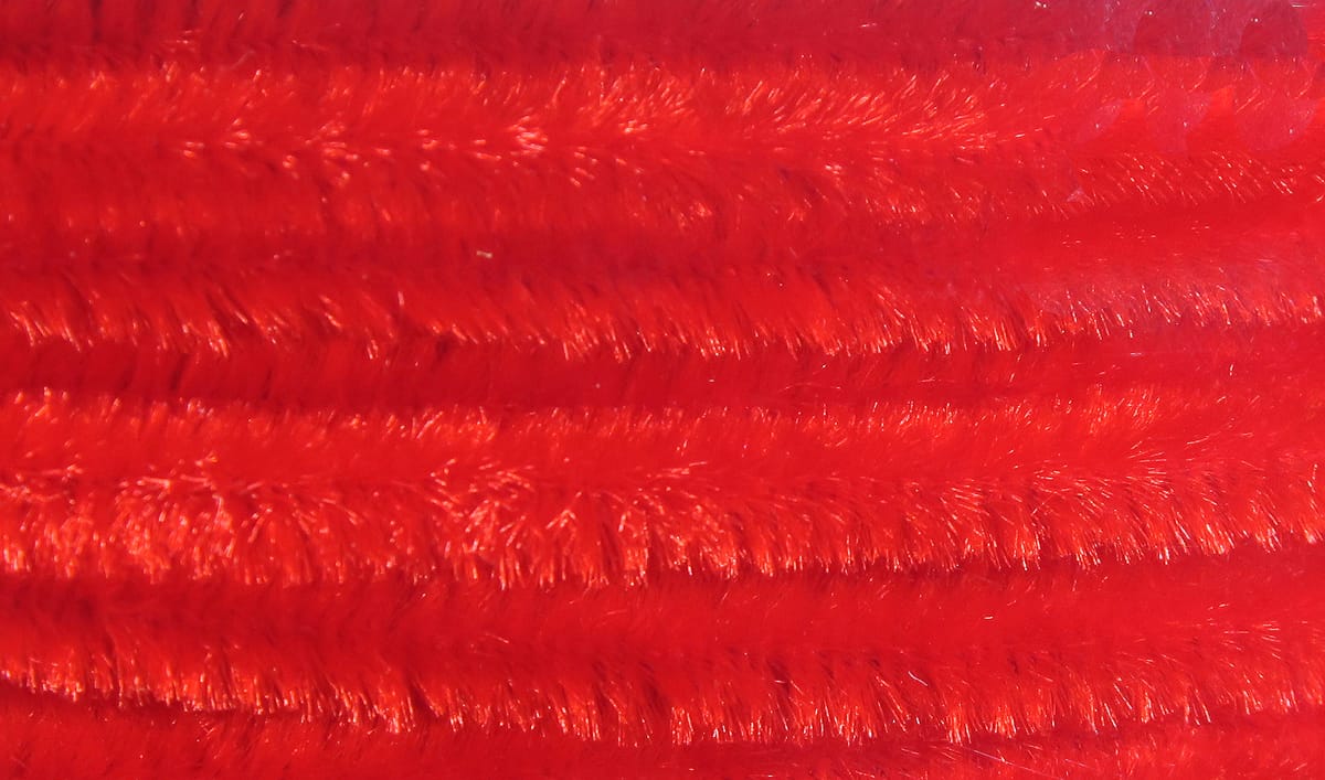 Hareline red chenille with dense fuzzy fibers and subtle iridescent sheen, ideal for fly tying materials