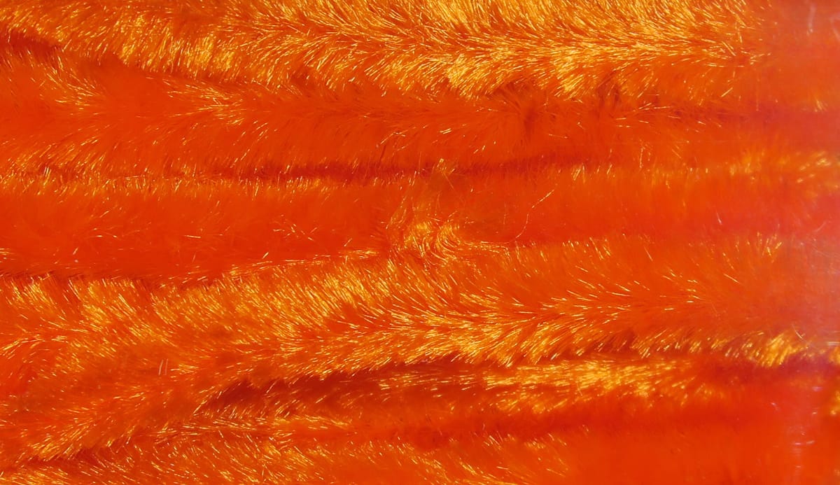 Bright orange Hareline chenille, fuzzy iridescent synthetic fibers with shimmering texture for fly tying