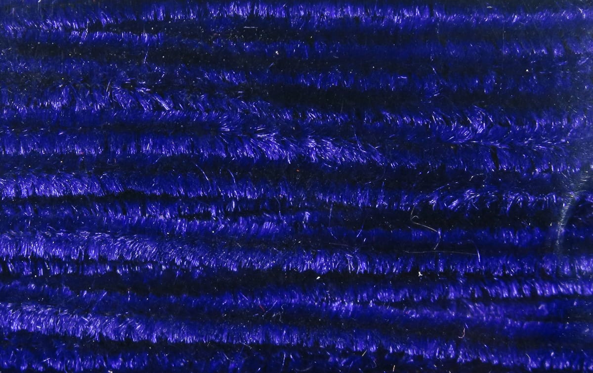 Deep royal blue chenille fibers, glossy fuzzy strands used for fly tying