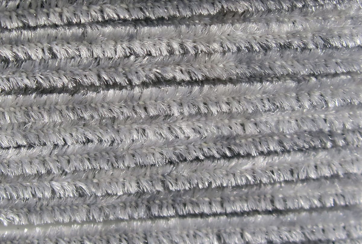 Silver-gray Hareline chenille stems with dense fuzzy fibers and metallic sheen for fly tying