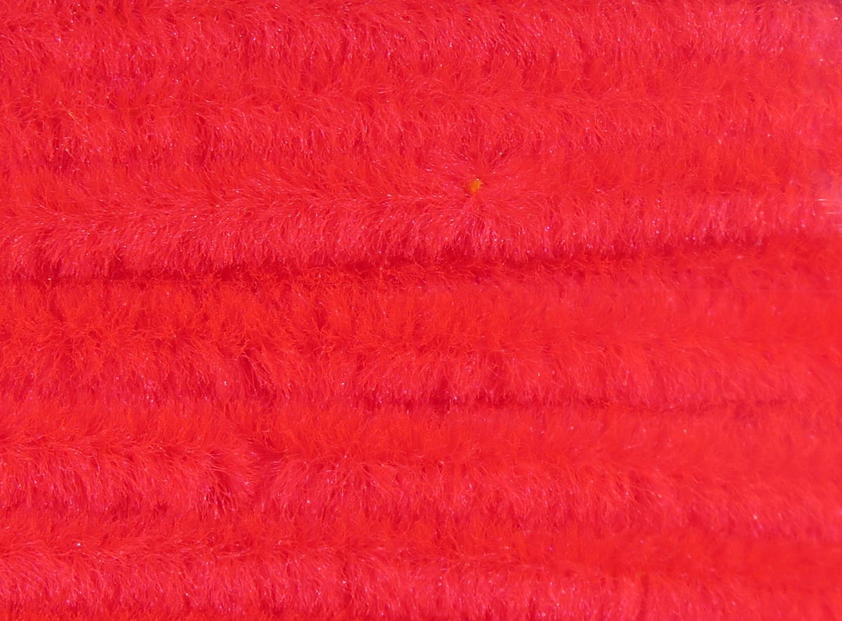 Bright red Hareline chenille with dense fuzzy fibers and subtle sparkle, fly tying material