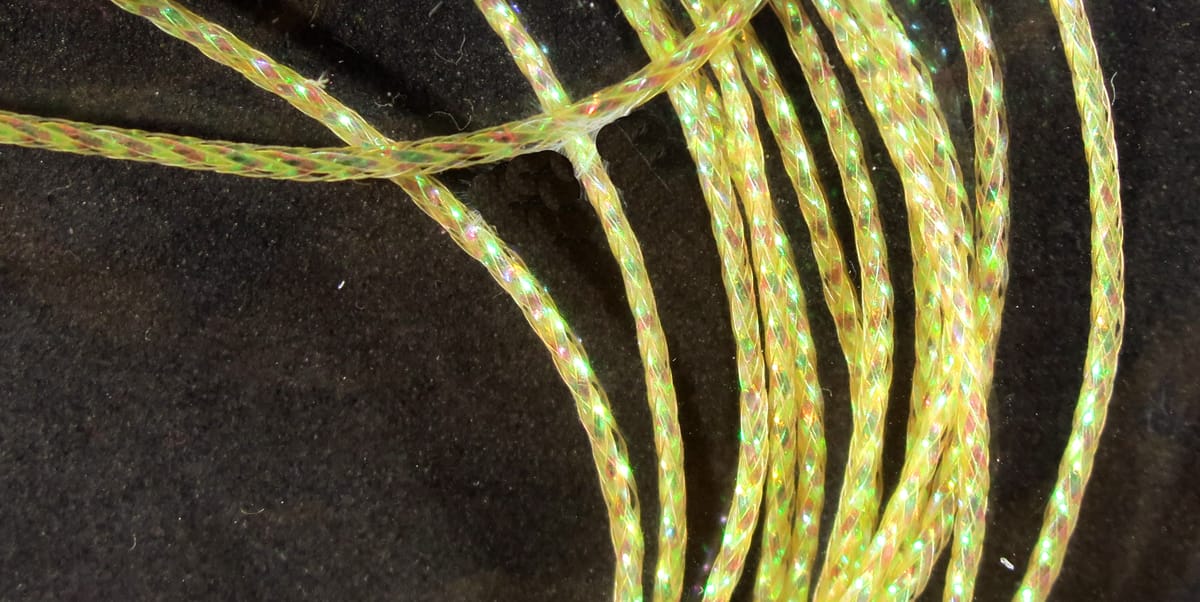 Iridescent pale yellow-green braided synthetic chironomid braid with sparkly reflective fibers for fly tying