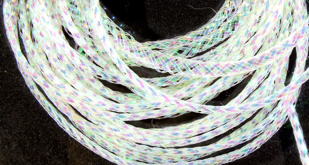 Iridescent white Hareline chironomid braid, synthetic fly tying braid with pink blue green flashes on black