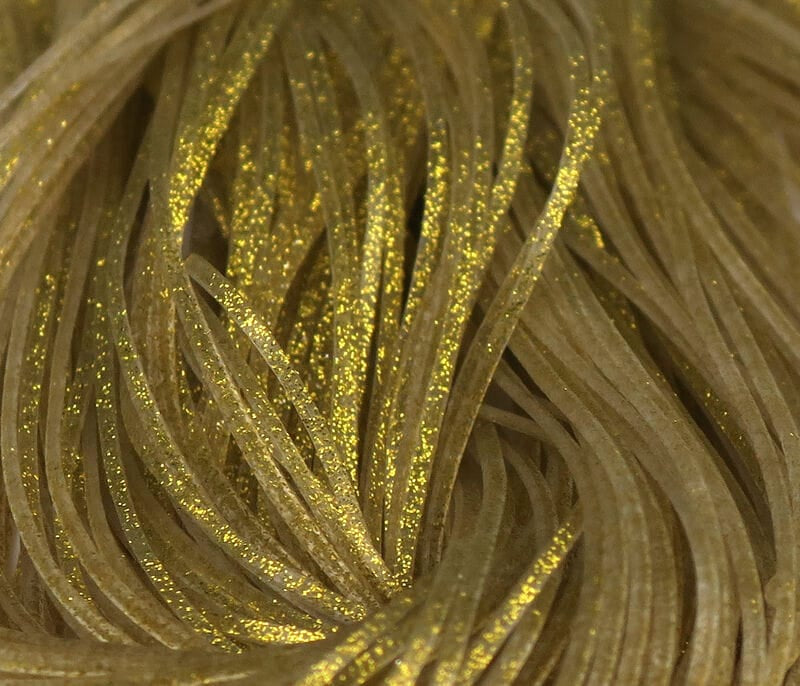 Hareline Crazy Legs fly tying strands: olive-brown silicone legs with gold glitter flakes, flat ribbon style for lures