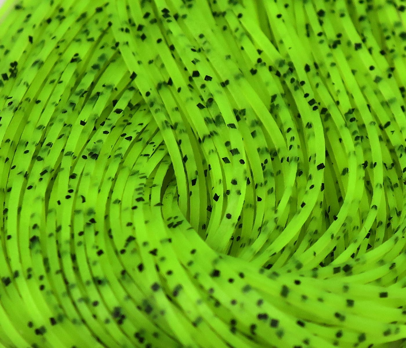Neon chartreuse Hareline Crazy Legs rubber strands with black speckles, coiled synthetic legs for fly tying