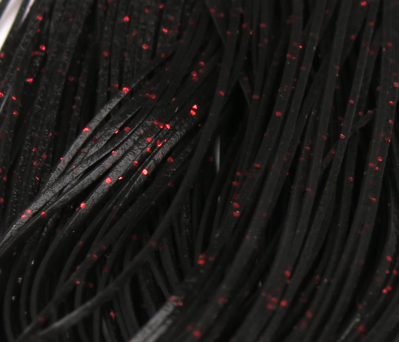 Black rubber Crazy Legs with red glitter flecks, flat synthetic strands for fly tying