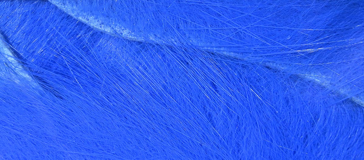 Bright royal blue Hareline crosscut rabbit fur strips with fine silky hairs and glossy guard hairs for fly tying