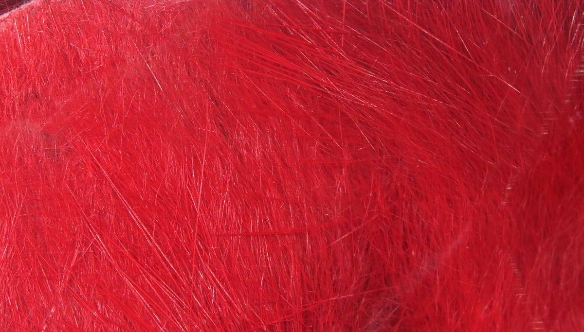 Bright red Hareline crosscut rabbit fur strips, dense soft underfur with longer guard hairs for fly tying