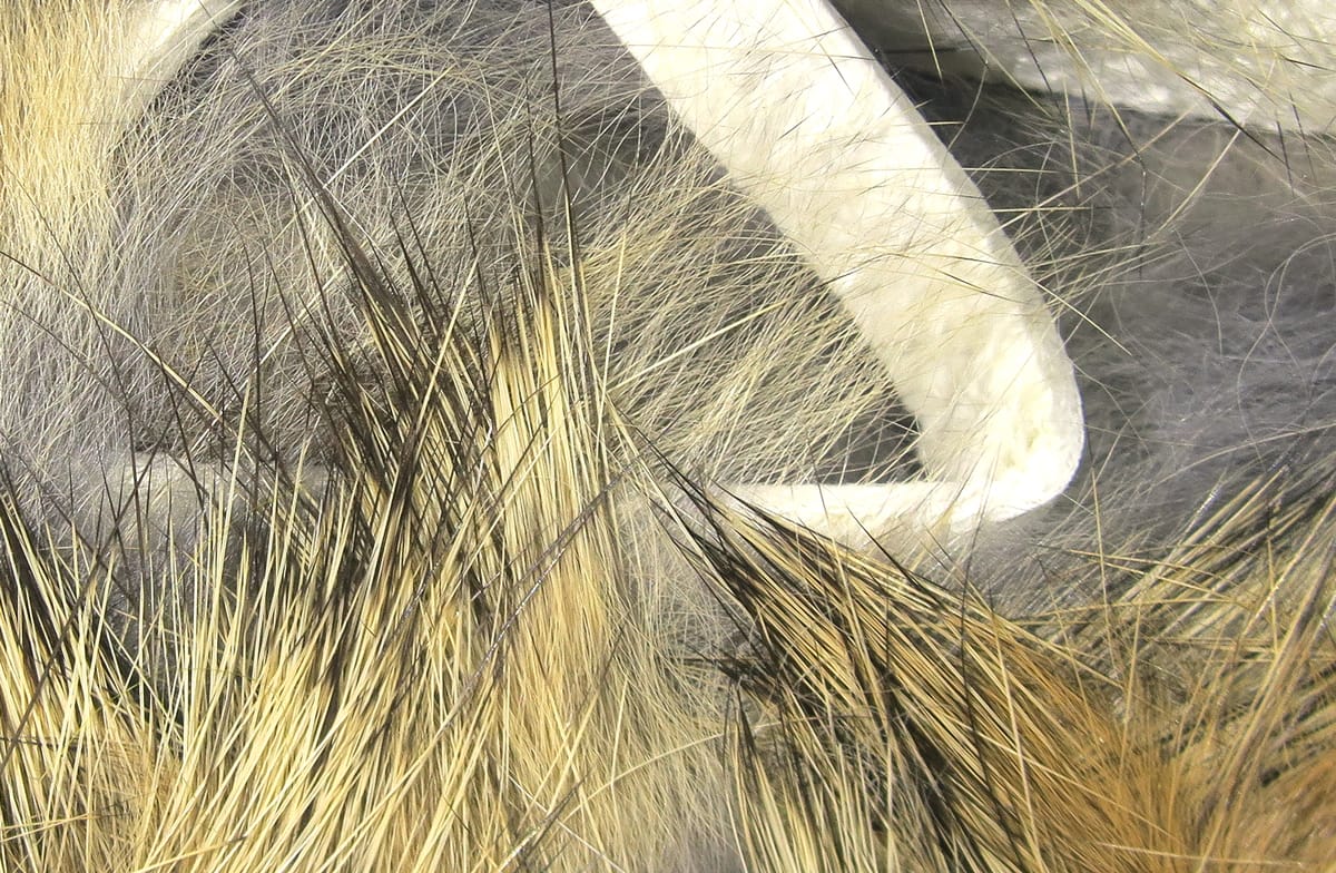 Hareline crosscut rabbit fur strips in tan and gray with long guard hairs and soft underfur for fly tying