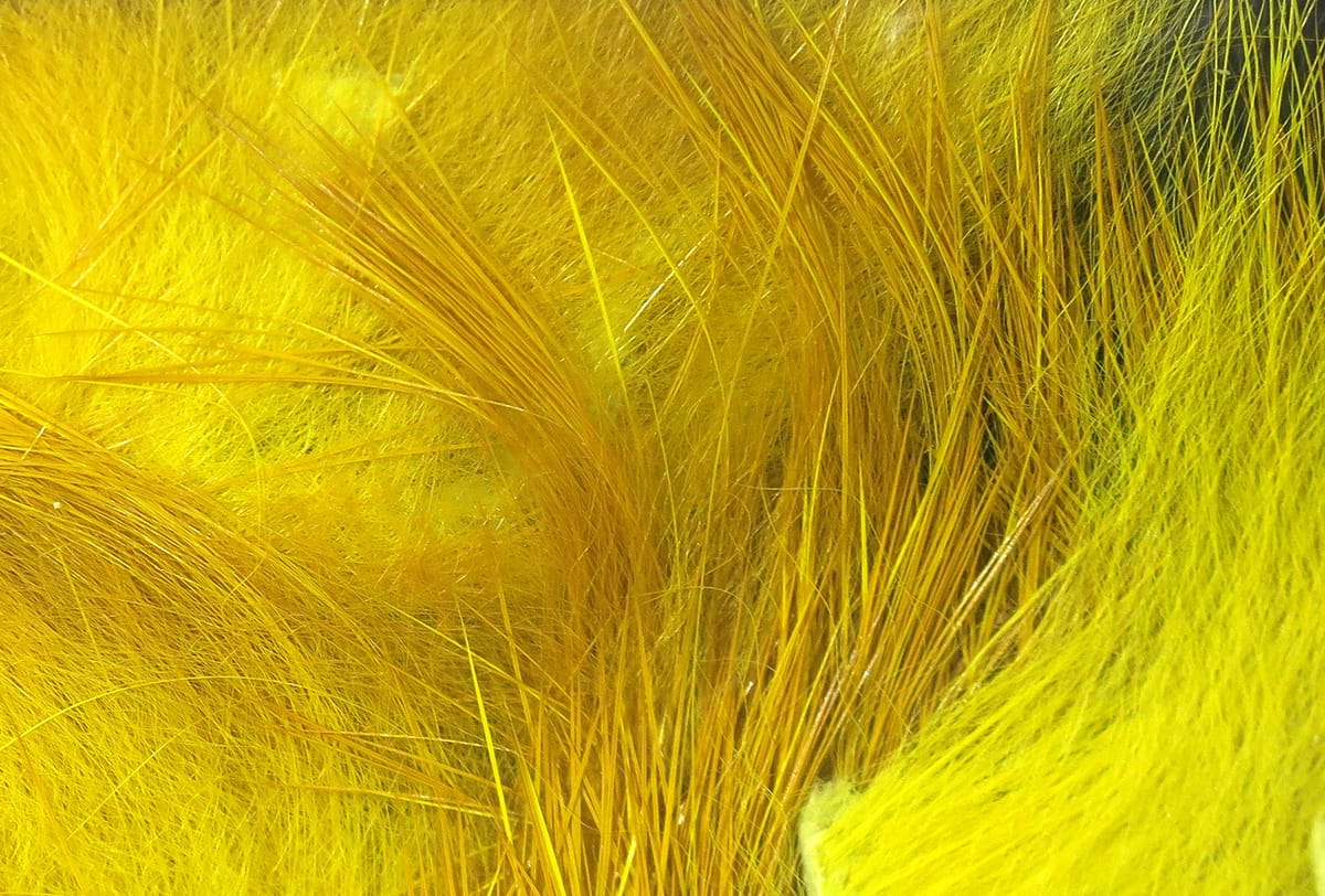 Bright yellow Hareline crosscut rabbit fur strips with long guard hairs and soft underfur for fly tying