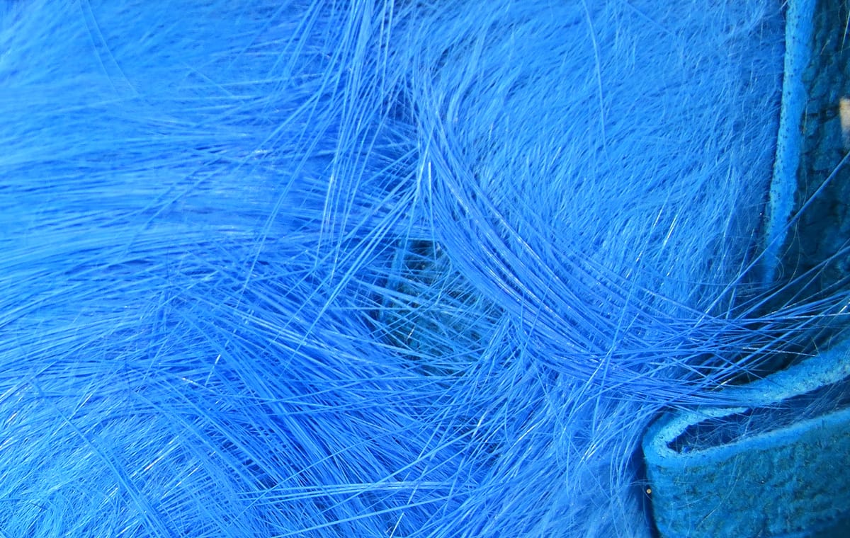 Bright blue crosscut rabbit fur strips with long silky fibers and suede leather backing for fly tying