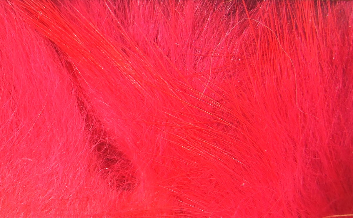 Bright hot pink Hareline crosscut rabbit fur strips with long guard hairs and soft underfur for fly tying