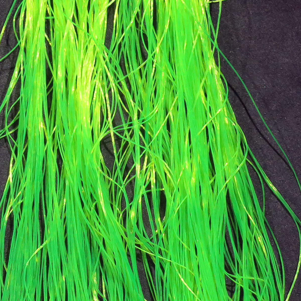Hareline Daddy Long Legs bright chartreuse synthetic fly tying fibers with long thin iridescent strands on black background