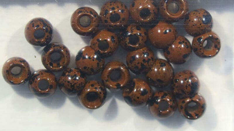 Hareline Dazzle brass beads, glossy brown round beads with black speckles and large center holes for fly tying