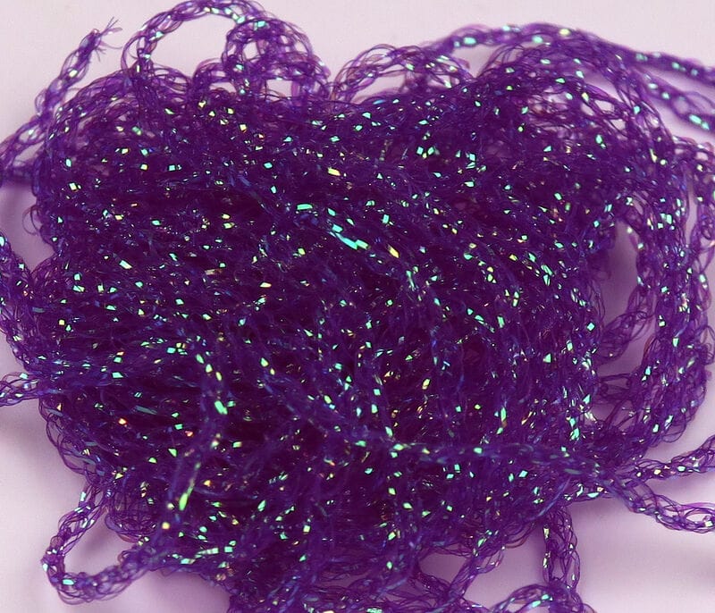 Tangled purple Hareline Diamond Braid skein with iridescent green-blue flash, braided synthetic material for fly tying