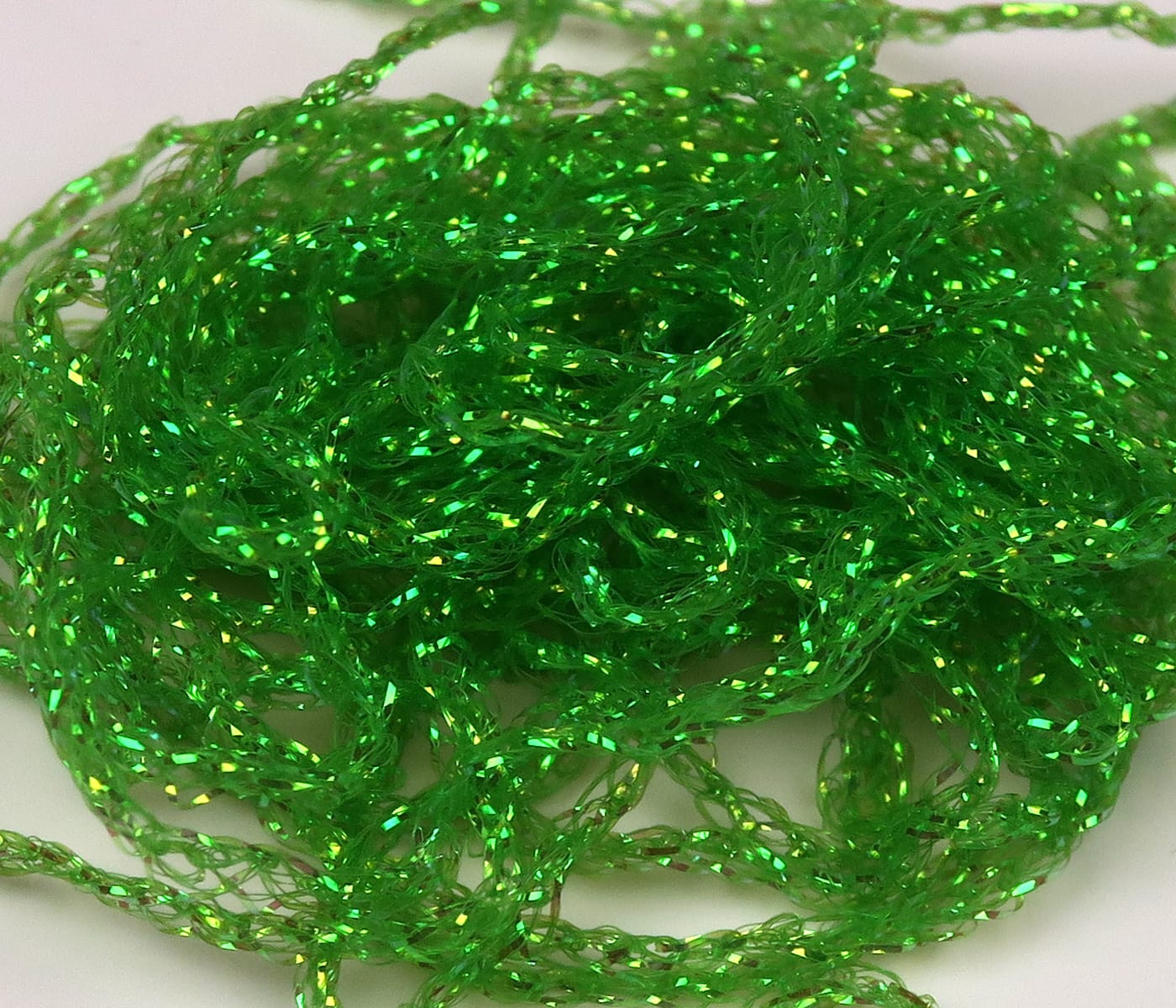 Emerald green Hareline Diamond Braid tinsel, braided translucent strands with iridescent flakes for fly tying
