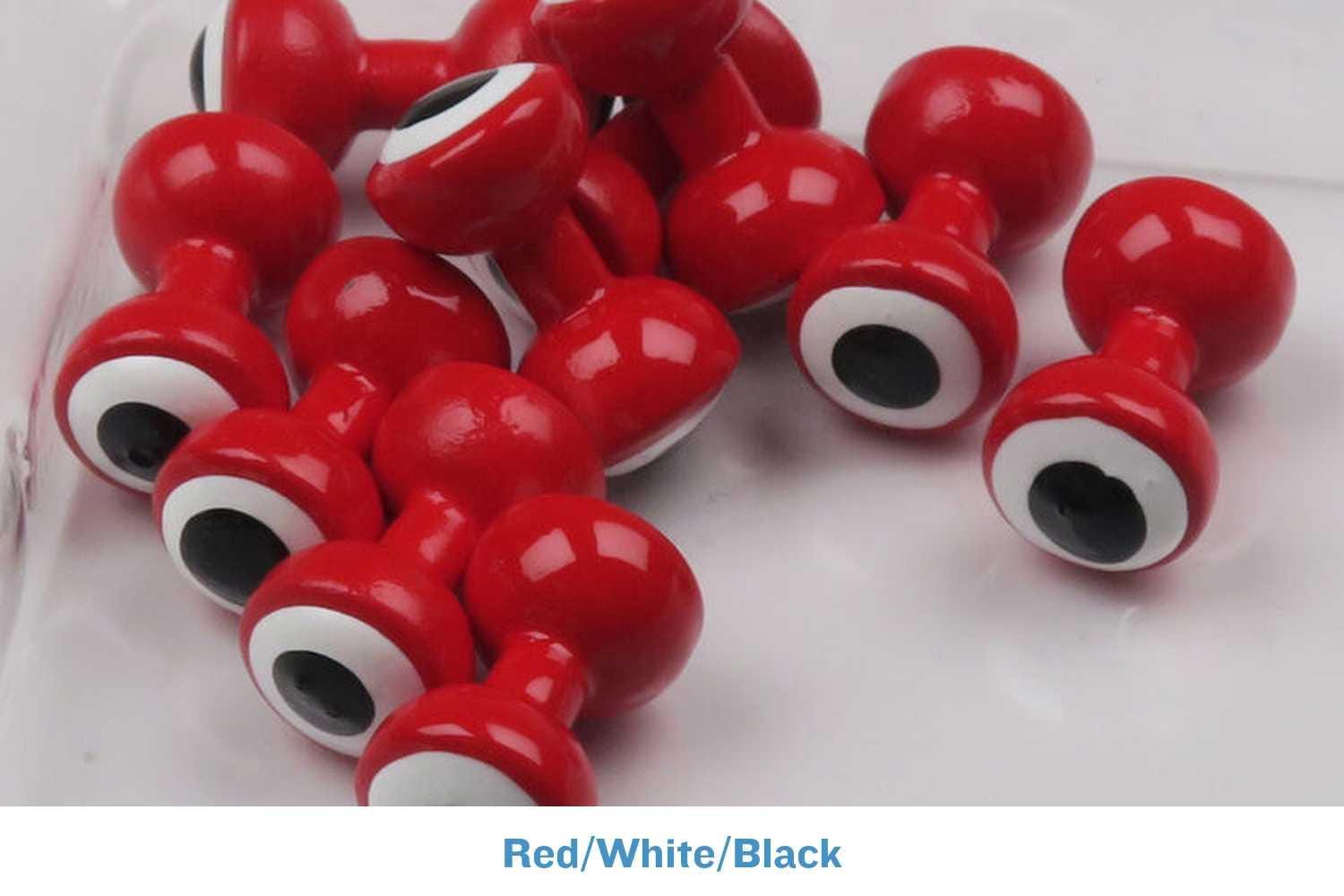 Glossy red double-pupil brass eyes with white and black pupils, dumbbell-style fly tying eyes