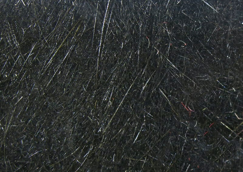 Hareline Dubbin black synthetic fibers with fine iridescent flash and dense fur-like texture for fly tying