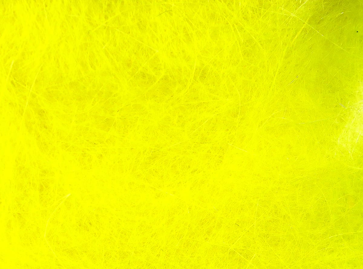 Bright chartreuse yellow Hareline Dubbin synthetic dubbing fibers with fine furry texture for fly tying
