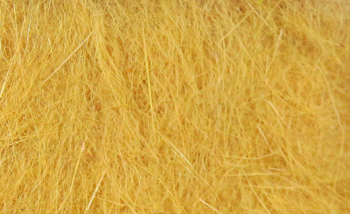 Hareline golden yellow dubbing fibers for fly tying, fine soft fur-like strands with a few guard hairs
