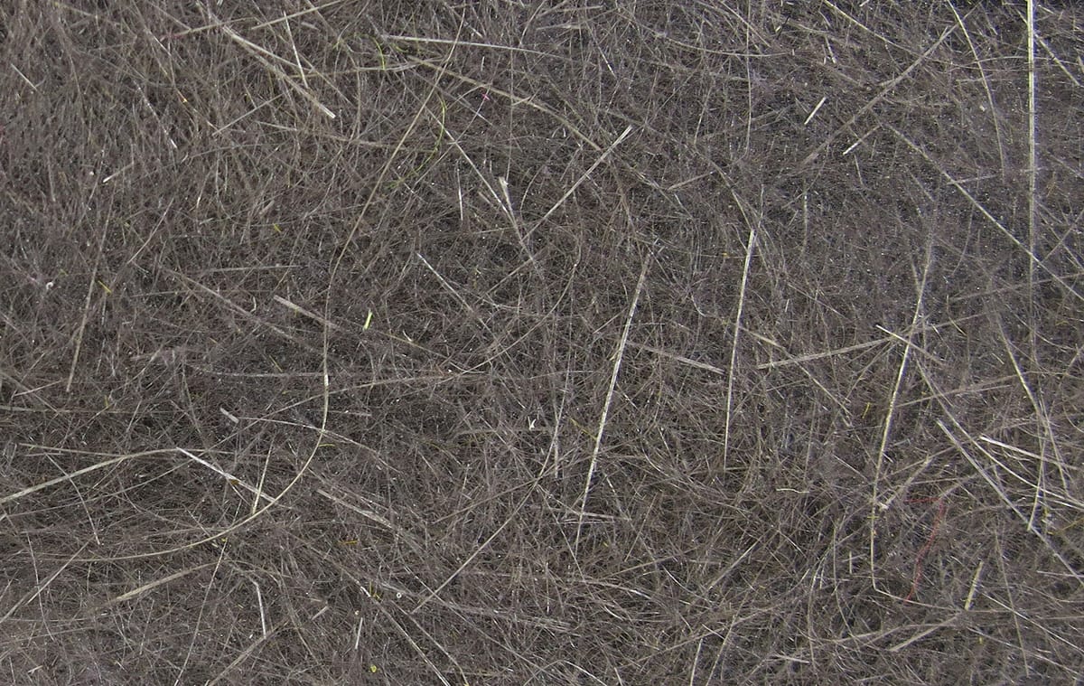 Hareline dubbin close-up showing fine dark gray hare fur dubbing fibers with lighter guard hairs for fly tying