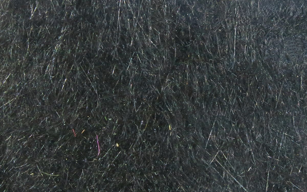 Black synthetic dubbing with fine iridescent flash fibers, fluffy textured material for fly tying