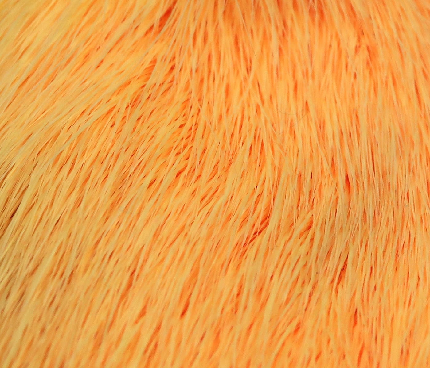 Bright orange dyed deer belly hair with fine soft strands for fly tying, close-up