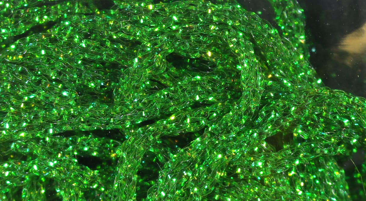 Bright green Hareline dyed pearl diamond braid, sparkly translucent braided nylon strands for fly tying