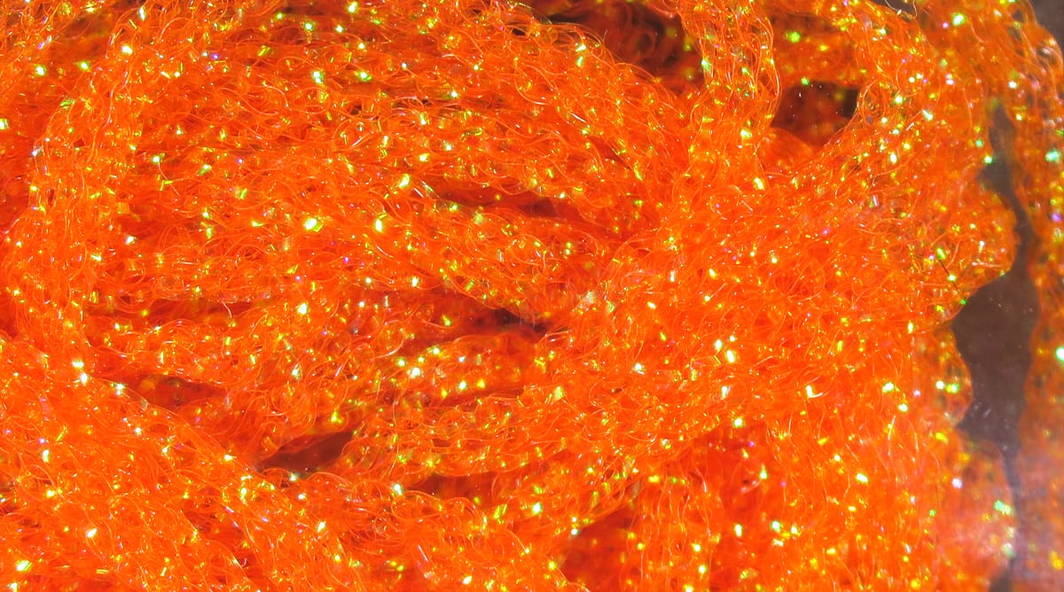 Hareline dyed pearl diamond braid in bright orange, braided synthetic fibers with iridescent sparkle and flecks