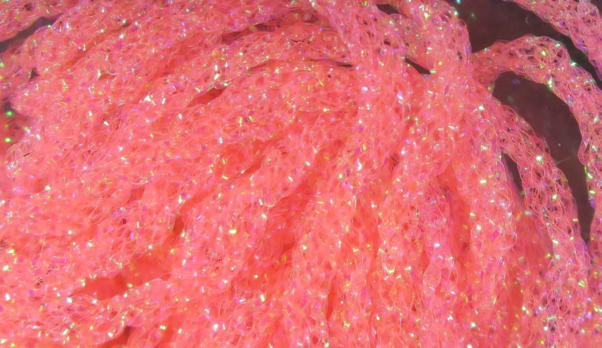 Hareline dyed pearl diamond braid in fluorescent pink coral, iridescent synthetic braided tubing for fly tying